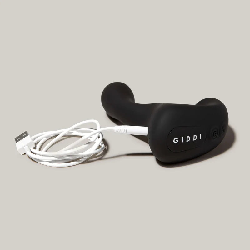 Black Mygiddi device with USB cable on a gray background
