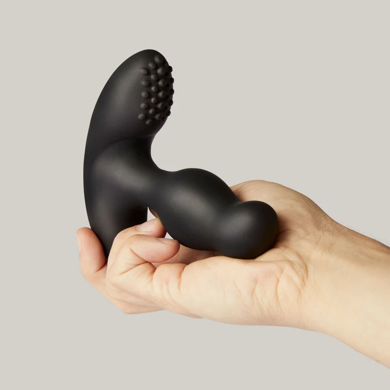 giddi thor rotating prostate massager held in a hand against a neutral background