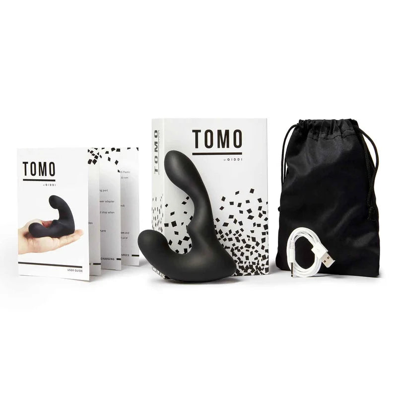 TOMO product packaging with black silicone product, branded box, and drawstring bag on a white background