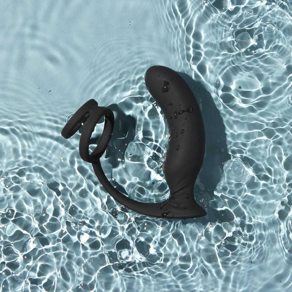 Black rubber duckie on clear water surface