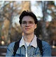 Person outdoors wearing glasses and a denim jacket.